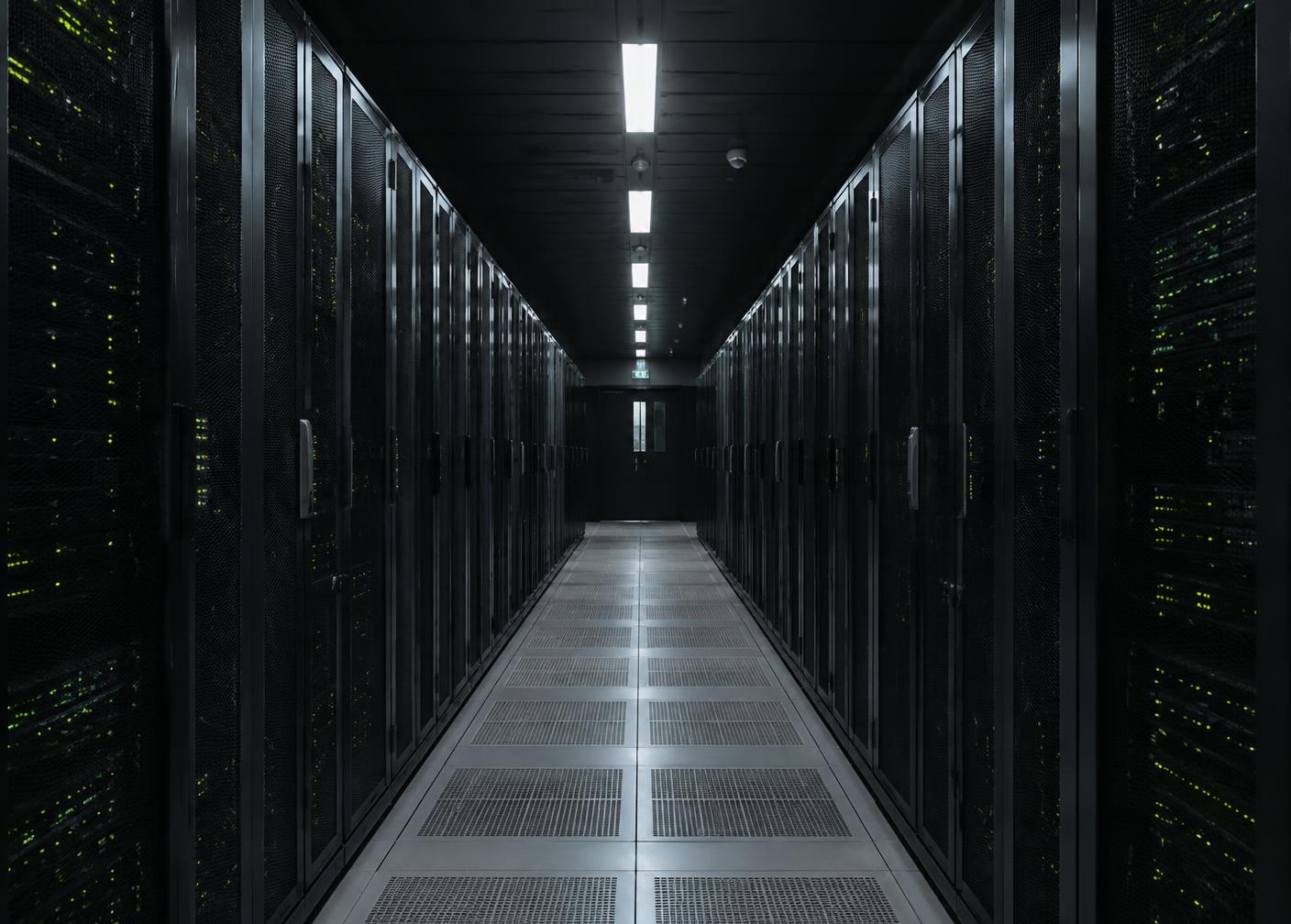 Server racks with green status lights in a data centre aisle